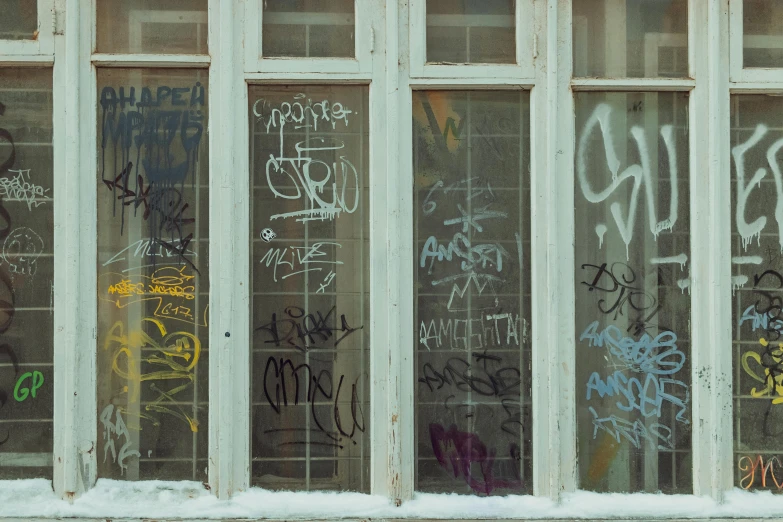 a window covered in lots of graffiti next to a fire hydrant, pexels, rows of doors, norilsk, antoni tapies and cy twombly, (3 are winter