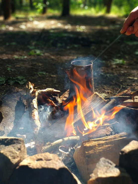 a person roasting marshmallows over a campfire, pexels contest winner, hurufiyya, smoke rising from the pipe, soup, william penn state forest, may)