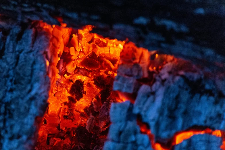 a close up of a burning piece of wood, by Adam Marczyński, pexels contest winner, blue and orange lighting, avatar image, hot food, volcanic