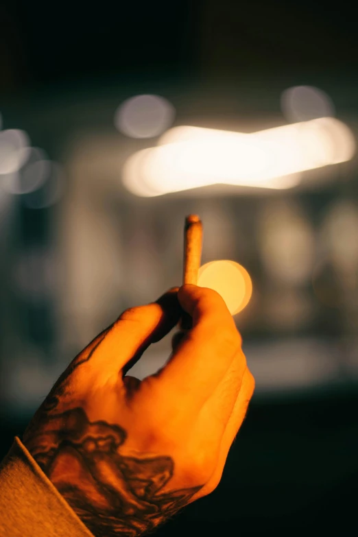 a close up of a person holding a cell phone, an album cover, inspired by Elsa Bleda, pexels contest winner, smoking a bowl of hash together, evening lights, launching a straight ball, shot from a distance