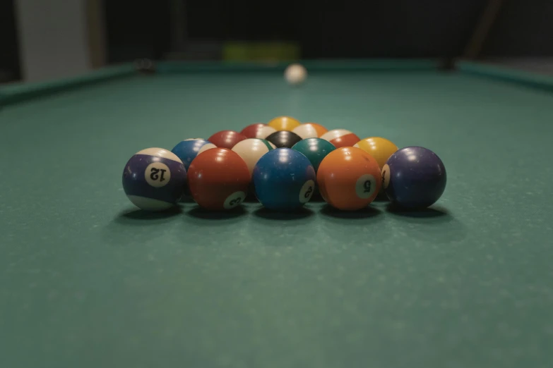 a pile of billiard balls sitting on top of a pool table, by Elsa Bleda, unsplash, photorealism, multicolored, medium shot angle, cinematic shot ar 9:16 -n 6 -g, multi colored