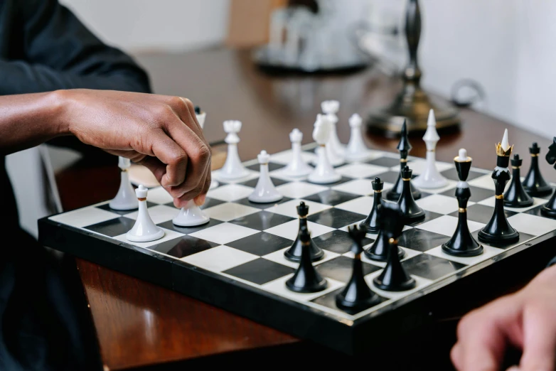 two men playing a game of chess on a table, by Carey Morris, pexels contest winner, on a coffee table, private school, thumbnail, black man