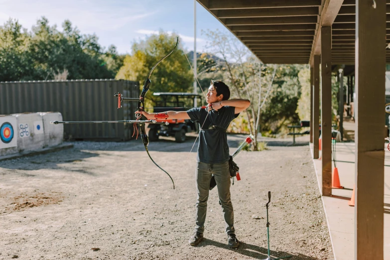 a man that is standing in the dirt with a bow, profile image