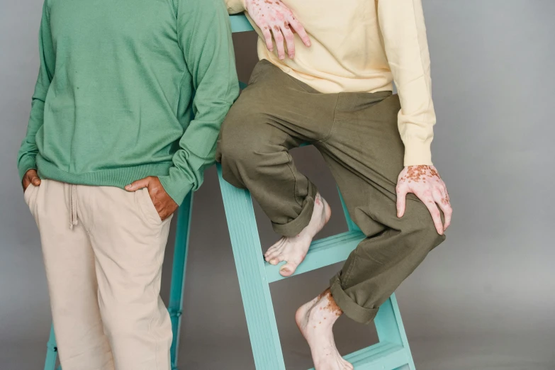 a man sitting on a ladder next to another man, by Liza Donnelly, trending on pexels, renaissance, green legs, pastel clothing, dementia, visible veins