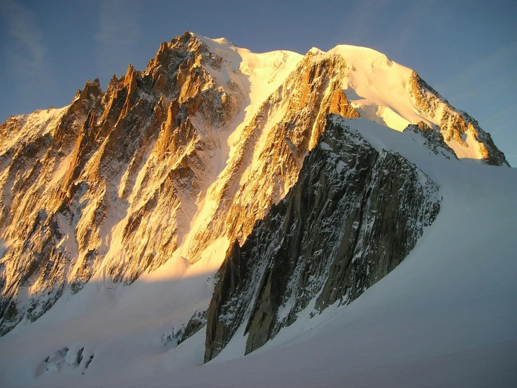 a mountain covered in snow under a blue sky, pexels contest winner, les nabis, evening sunlight, climbing, wikipedia, elevation