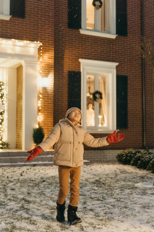 a little girl standing in the snow in front of a house, dancing lights, sony pictures, 2019 trending photo, realistic »