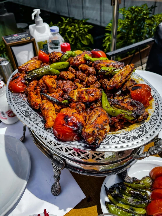 a close up of a plate of food on a table, by Abdullah Gërguri, barbecue, thumbnail, silver platter, chicken