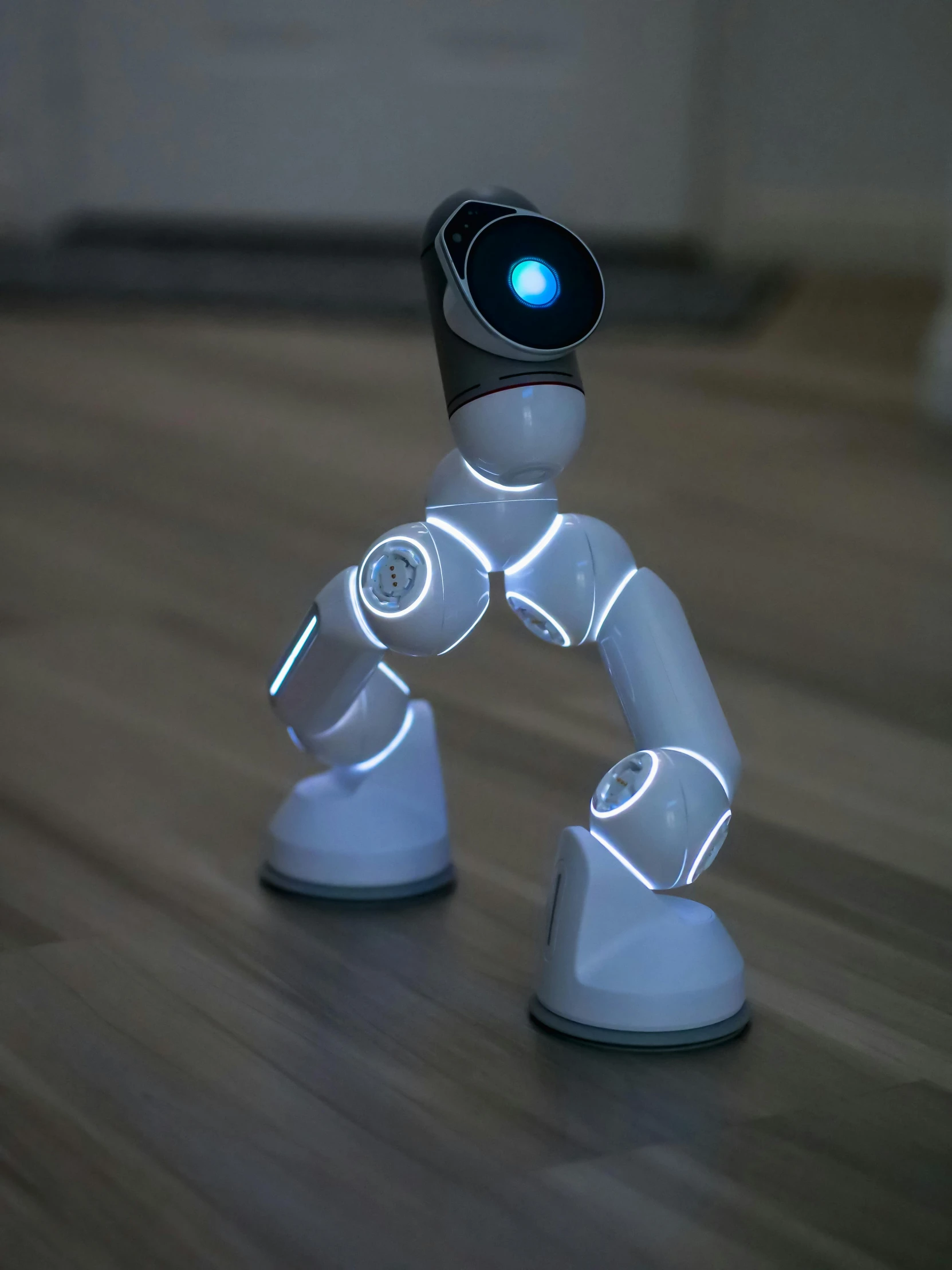 a white robot sitting on top of a wooden floor, dancing lights, salvia droid, avatar image, light sensor