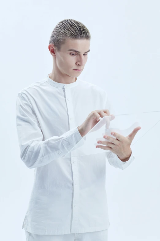 a man in a white shirt is holding something, an album cover, inspired by Fei Danxu, unsplash, holding a magic needle, andrea savchenko, ultra clear material, no - text no - logo