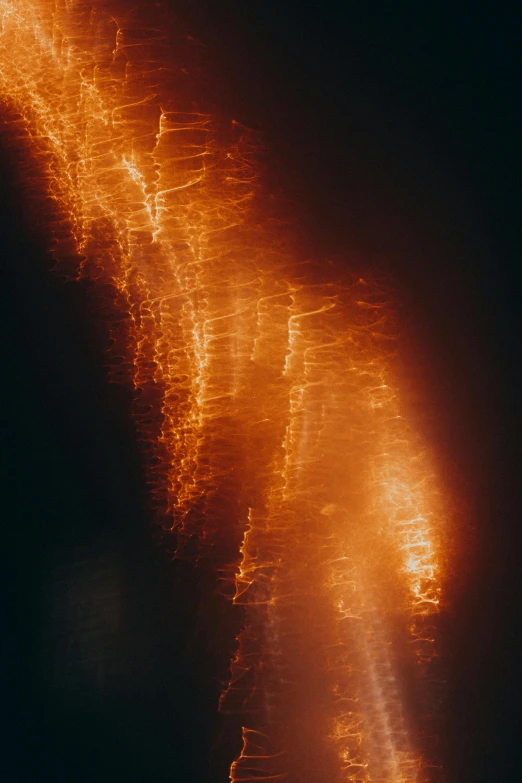 a blurry image of a street at night, an album cover, unsplash, lyrical abstraction, volcano texture, fire sparks, shot from drone, tall backlit waves