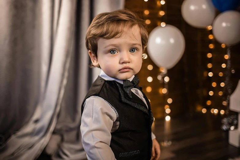 a little boy wearing a vest and tie, by Julia Pishtar, pexels contest winner, at a birthday party, anton semonov, elegant look, soft lights