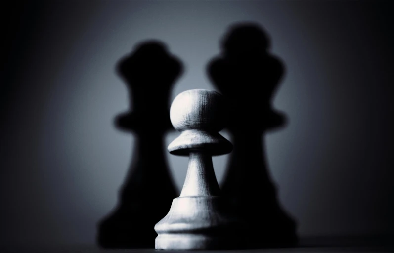 a couple of chess pieces sitting on top of a table, a black and white photo, by Adam Marczyński, precisionism, demur, shadow resolution, getty images, attacking