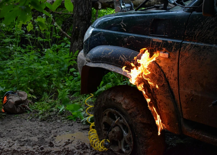 a car is on fire on the side of the road, pexels contest winner, auto-destructive art, stuck in mud, heated coils, avatar image, off-roading