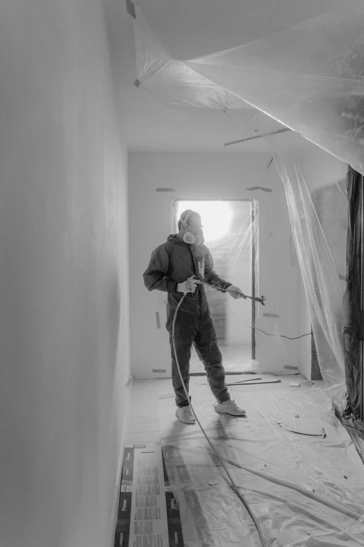 a black and white photo of a man in a room, action painting, worksafe. instagram photo, dust mask, interior photography, professional painting