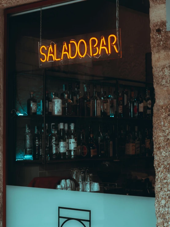 a bar with a neon sign that says sal ado bar, inspired by Elsa Bleda, trending on unsplash, happening, profile image, low quality photo, historical photo, close-up shot taken from behind