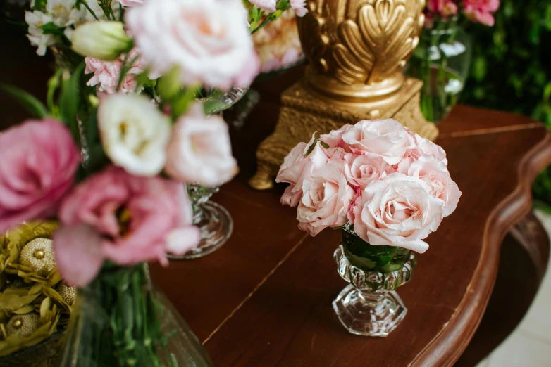 a table topped with vases filled with pink and white flowers, inspired by Alexander Roslin, trending on unsplash, rococo, detail shot, pink rose, facing front, venetian glass