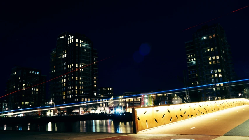 a fire hydrant sitting on top of a sidewalk next to a body of water, by Jan Tengnagel, interactive art, 1 glowing bridge crossing river, long exposure outside the city, all buildings on bridge, cinematic shot ar 9:16 -n 6 -g