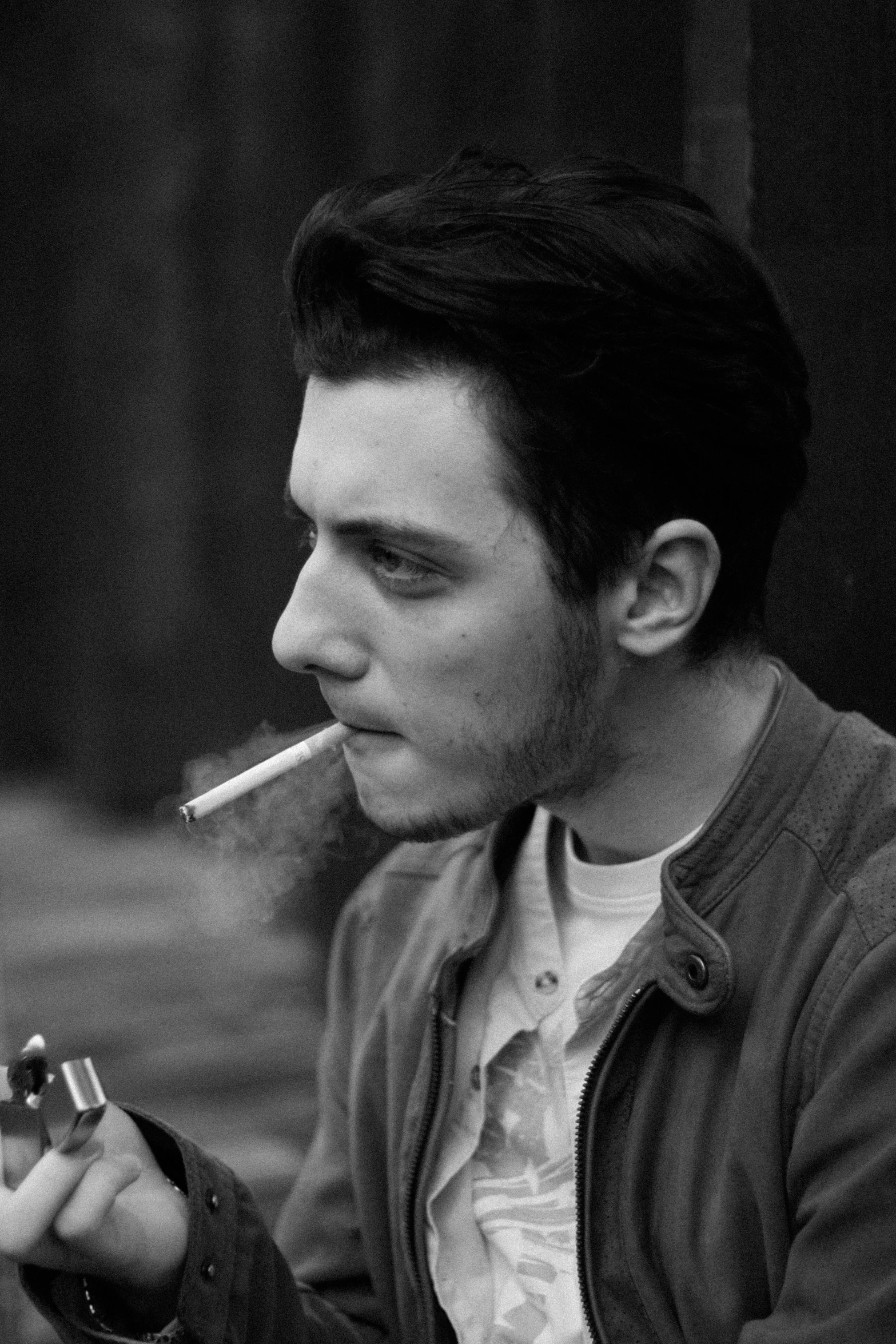 a black and white photo of a man smoking a cigarette, inspired by William Michael Harnett, flickr, fantastic realism, pete davidson, around 1 9 years old, tom burke, moody : : wes anderson