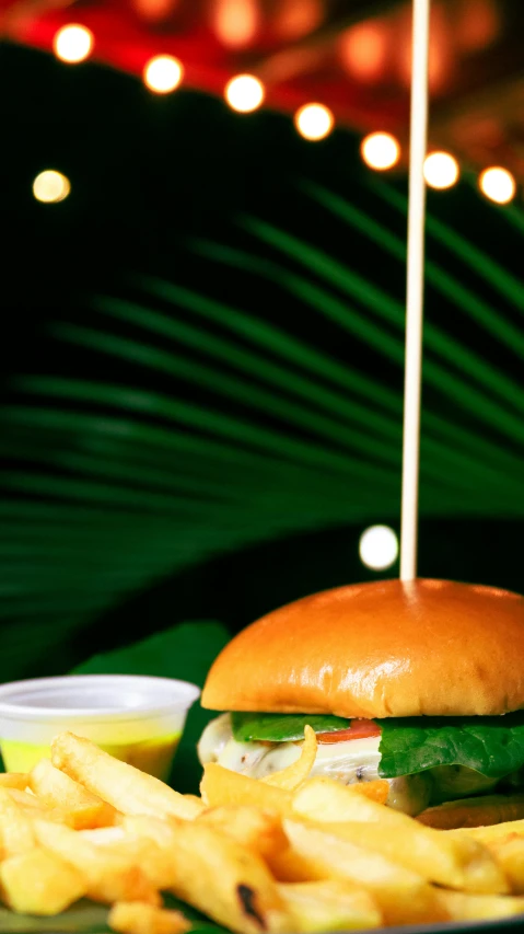 a hamburger and french fries on a plate, a digital rendering, unsplash, tropical foliage, 1980s photo, parasol, ..'