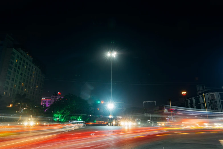 a city street filled with lots of traffic at night, by Alejandro Obregón, unsplash, realism, street light, bangalore, grassy knoll, abstract lighting