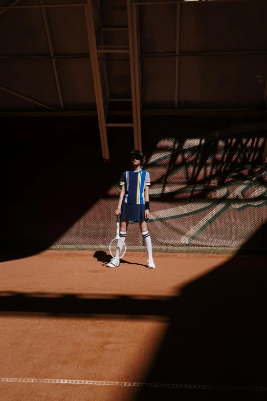 a man standing on top of a tennis court holding a racquet, fashion editorial, alessio albi and shin jeongho, costume with blue accents, slide show