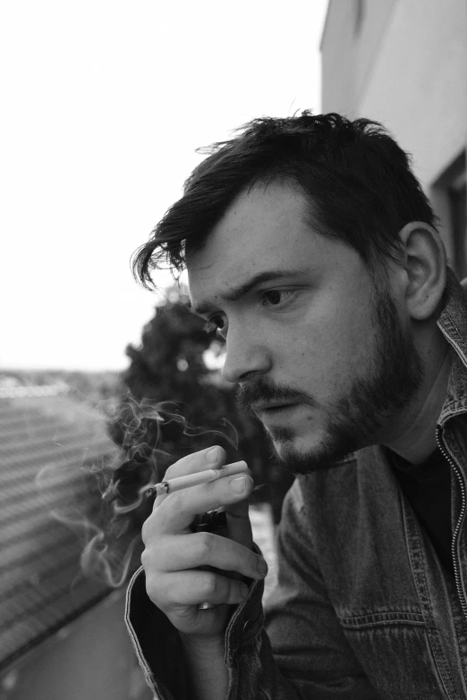 a black and white photo of a man smoking a cigarette, an album cover, by Felix-Kelly, reddit, hyperrealism, tom burke, discord profile picture, parks, people