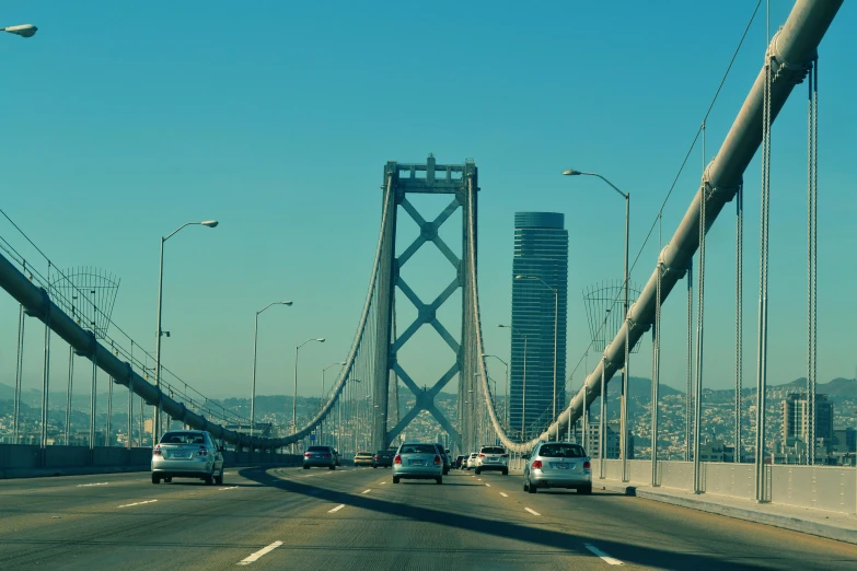 a group of cars driving across a bridge, pexels contest winner, renaissance, bay area, skyscrapers in the distance, slide show, promo image