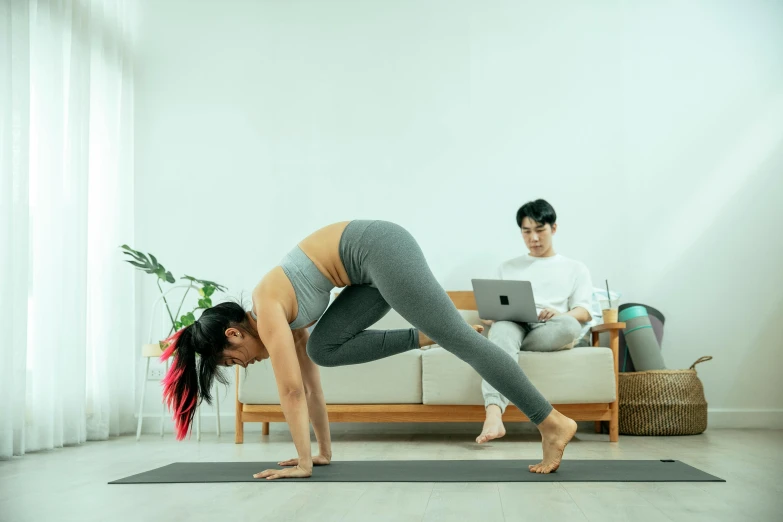 a woman doing a yoga pose on a yoga mat, a hologram, pexels contest winner, arabesque, ruan jia and brom, in front of a computer, lower quality, kuang hong