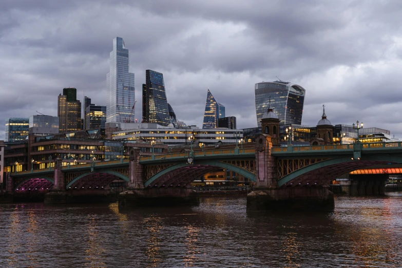 a bridge over a body of water with a city in the background, by Jay Hambidge, pexels contest winner, hyperrealism, london south bank, overcast dusk, three towers, gigapixel photo