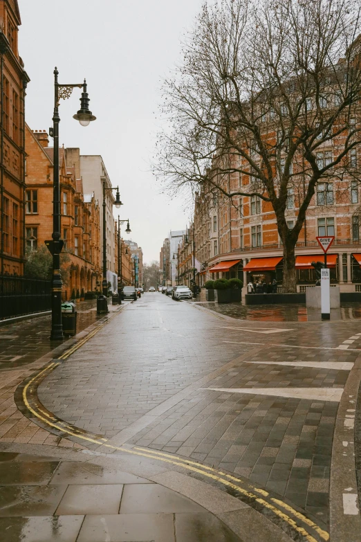 a red fire hydrant sitting on the side of a road, by Nina Hamnett, pexels contest winner, art nouveau, on a wet london street, wide long view, umbrellas, on a great neoclassical square