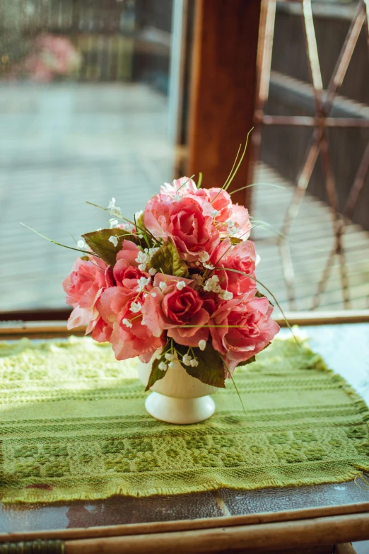 a vase filled with pink flowers sitting on top of a table, romanticism, commercially ready, lush vista, petite, rose twining