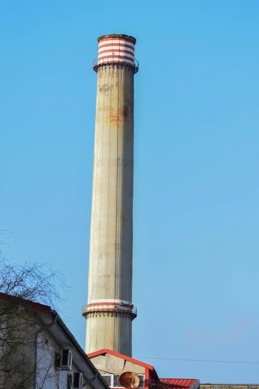 a tall brick chimney sitting next to a building, inspired by Juraj Julije Klović, in ruined agora of athens, very long neck, ripple, circular