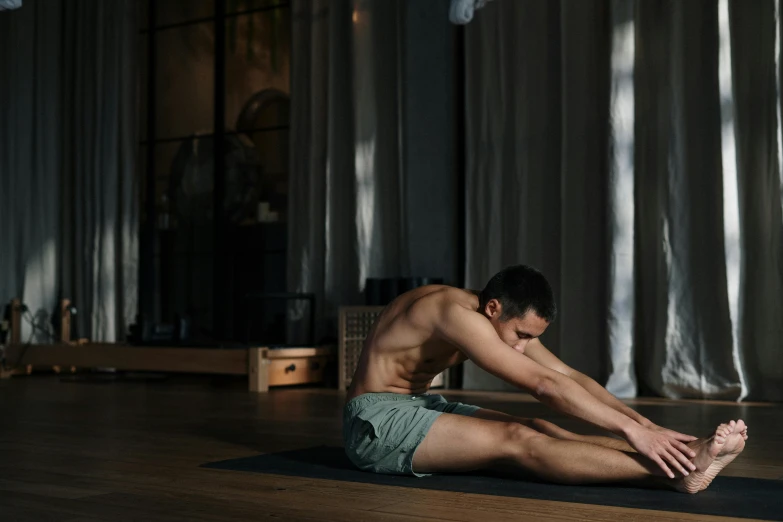 a shirtless man sitting on a yoga mat, pexels contest winner, renaissance, bent over posture, 30 year old man :: athletic, damien tran, indoor scene