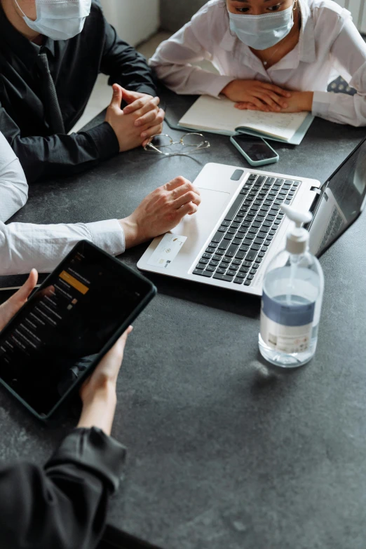 a group of people sitting around a table with laptops, by Carey Morris, pexels contest winner, corporate phone app icon, ad image, formulas, maintenance