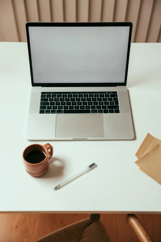 a laptop computer sitting on top of a white desk, by Robbie Trevino, trending on unsplash, coffee cup, writing a letter, 9 9 designs, brown