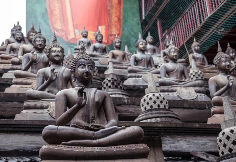 a group of buddha statues sitting next to each other, black and terracotta, jakarta, platforms, lightweight