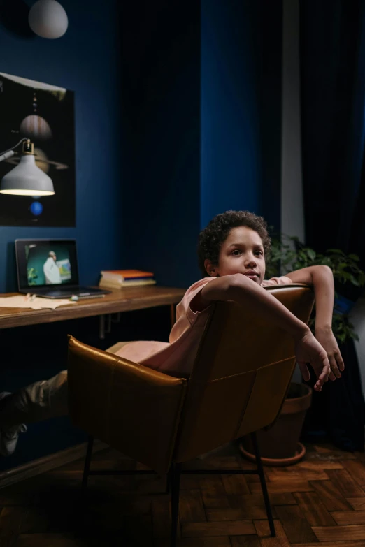 a person sitting in a chair in a room, a portrait, pexels contest winner, wide angle portrait of astroboy, moody blue lighting, tv commercial, at home