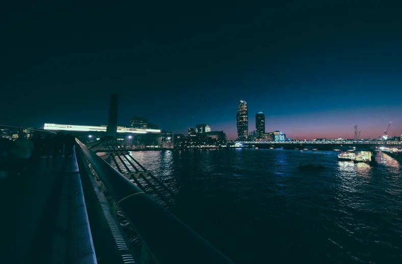 a view of a city at night from a bridge, pexels contest winner, view from the sea, instagram post, high quality photo, barcelona