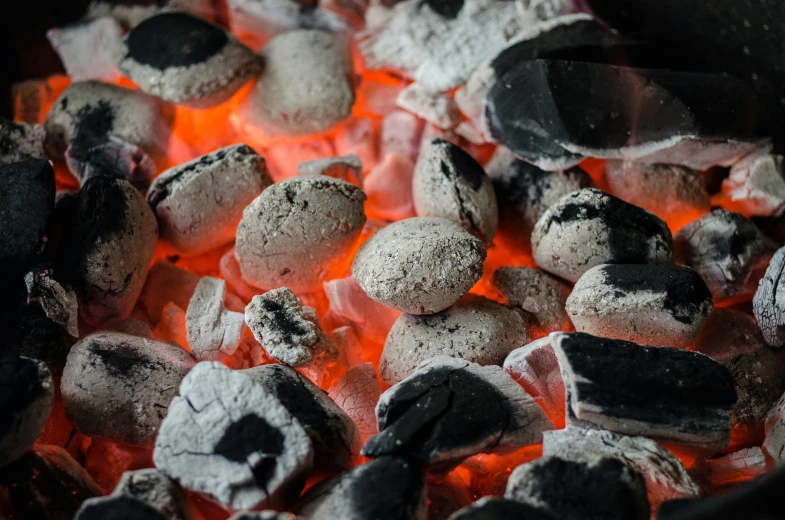 a close up of charcoal and coal in a grill, by Kazimierz Wojniakowski, pexels contest winner, coral-like pebbles, steamboat willy, shaded, youtube thumbnail