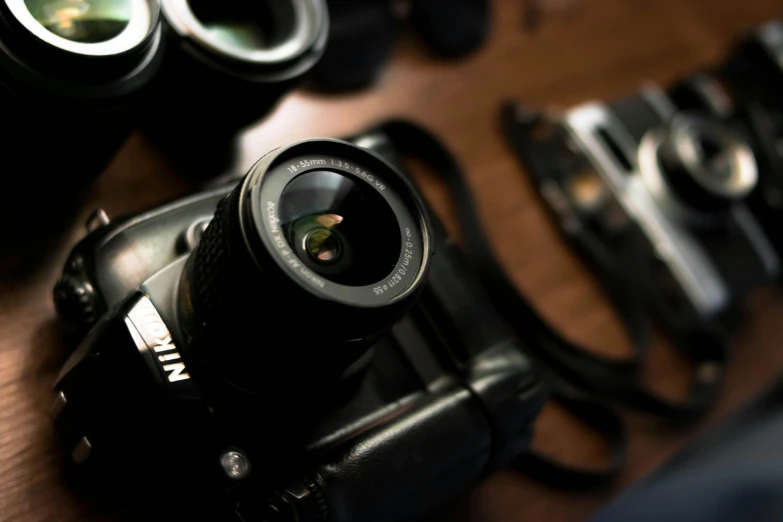 a camera sitting on top of a wooden table, a picture, looking down on the camera, lenses, ((sharp focus)), up close