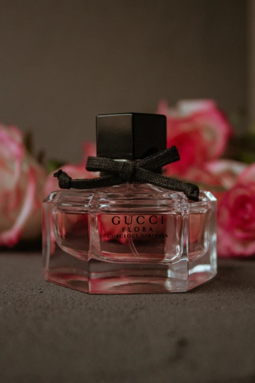 a bottle of perfume sitting on top of a table, a picture, guccimaze, ribbons and flowers, thumbnail, exterior shot