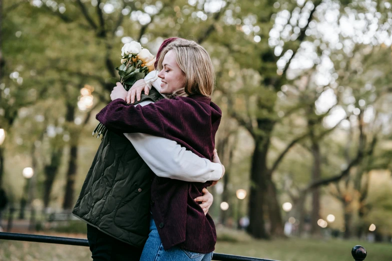 a couple hugging each other in a park, pexels contest winner, carrying flowers, sydney sweeney, lesbian, humans of new york