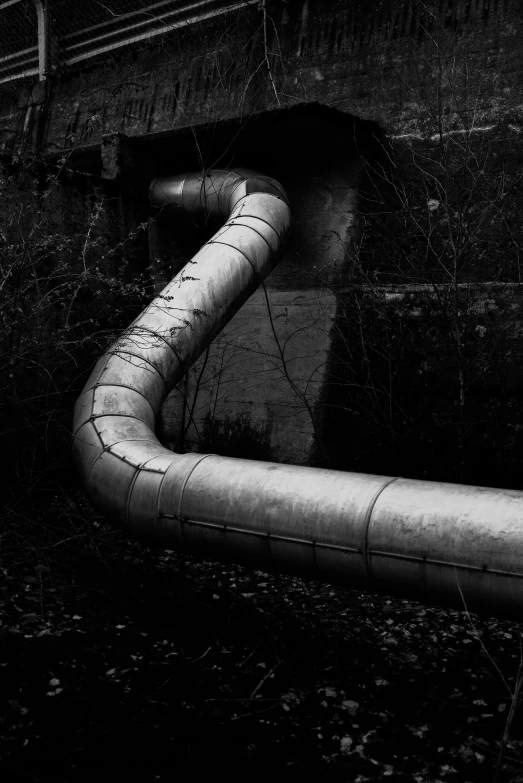 a black and white photo of a pipe, a black and white photo, conceptual art, [ metal ], egor letov, streams, made of metal