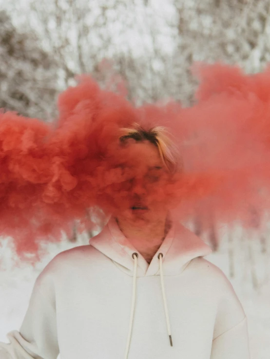 a man with red smoke coming out of his face, a colorized photo, trending on pexels, non binary model, winter vibes, made of cotton candy, androgynous person