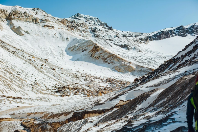 a man standing on top of a snow covered mountain, les nabis, a beautiful mine, top selection on unsplash, brown, landslides