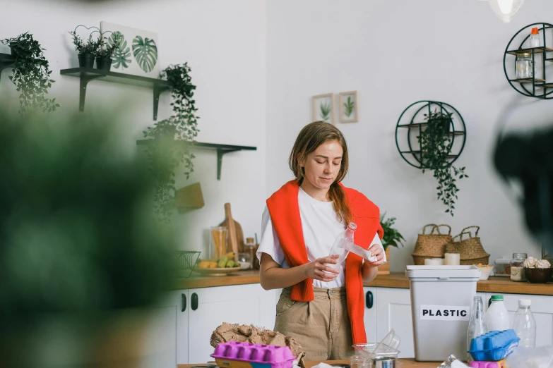 a woman standing in a kitchen preparing food, pexels contest winner, plasticien, holly herndon origami statue, profile image, inspect in inventory image, holding a bottle