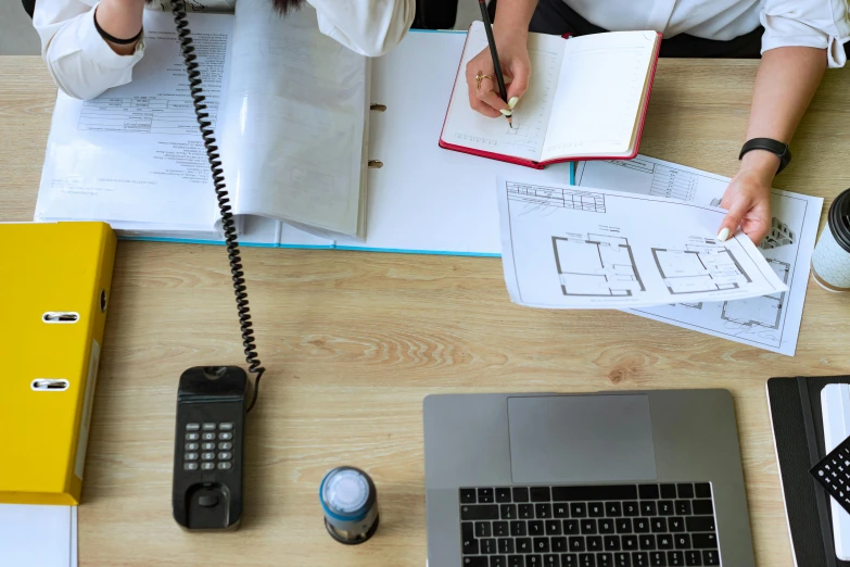 a woman sitting at a desk talking on a phone, a cartoon, trending on pexels, architectural plans, 90s photo, schematic in a notebook, 15081959 21121991 01012000 4k