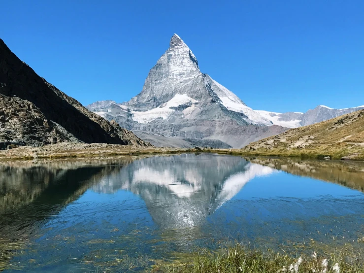 a body of water with a mountain in the background, by Werner Andermatt, pexels contest winner, fan favorite, mirror lake, avatar image, high definition photo