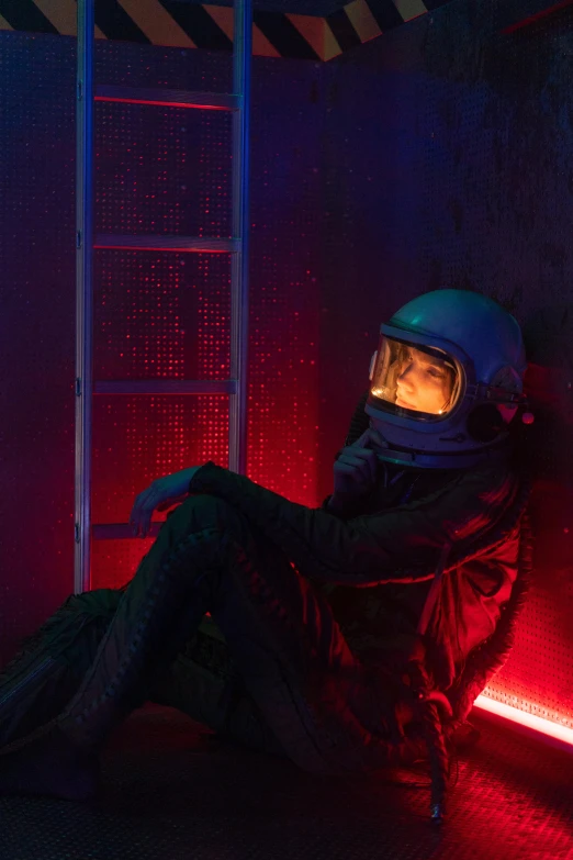 a person sitting in a chair with a helmet on, an album cover, inspired by Beeple, unsplash contest winner, in a space cadet outfit, photo of a model, nighttime, lost in thought