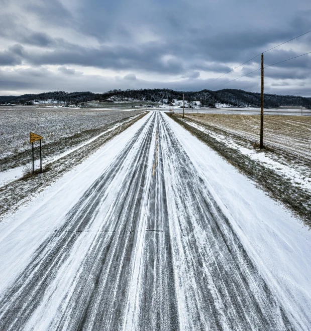 a road in the middle of a snow covered field, by Olaf Gulbransson, unsplash contest winner, land art, square, ai weiwei and gregory crewdson, snapchat photo, ilustration